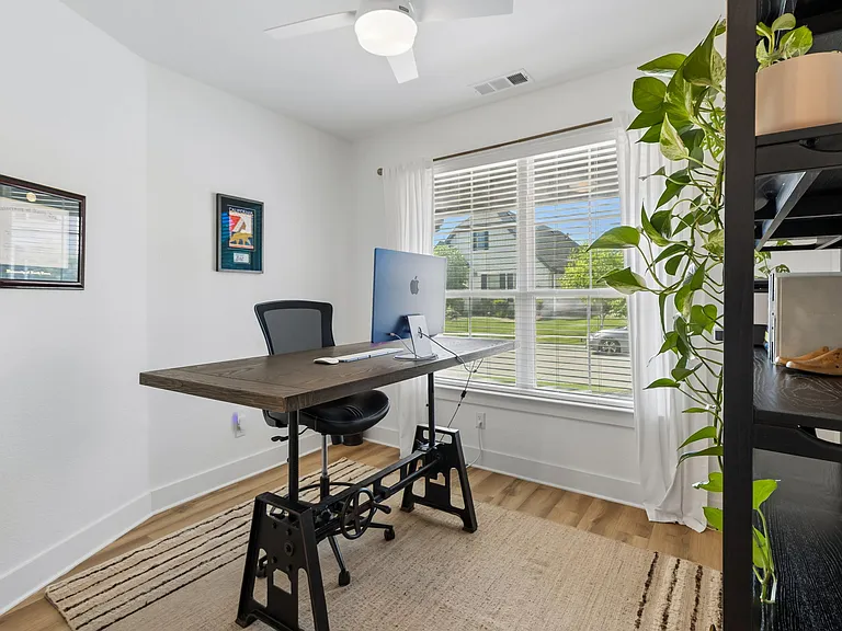 Office/study with adjustable standing desk and printer.
