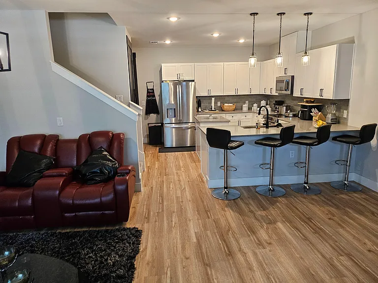Open-concept kitchen with a large breakfast bar, pendant lighting, and stainless steel appliances for easy everyday meals.