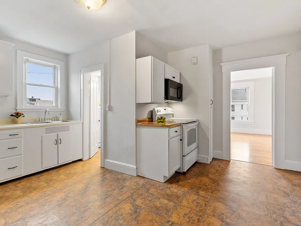 Kitchen and view into living room and bathroom.