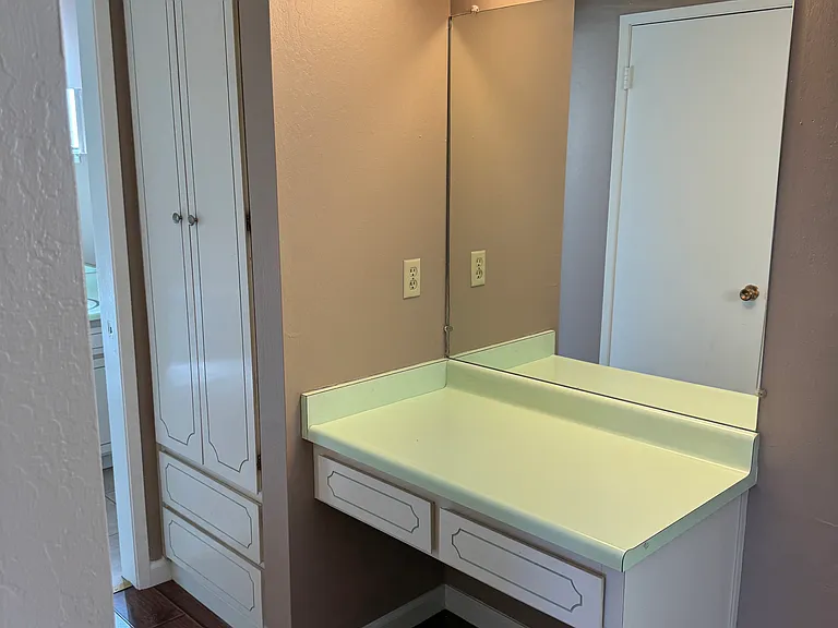 separate vanity in bedroom infront of walk in closet