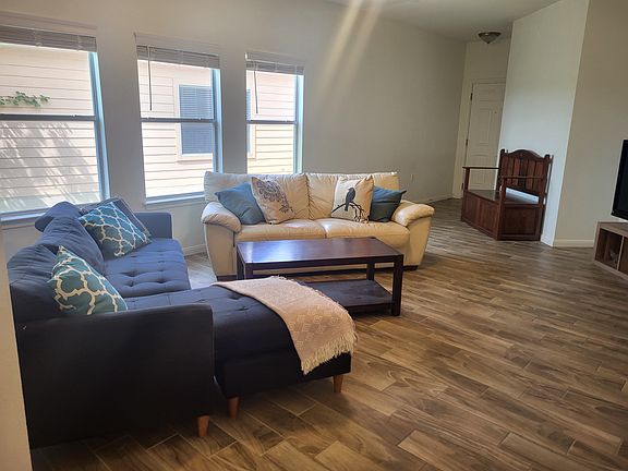 Living Room with High ceiling, Fan and Amazing Tile/wood floor