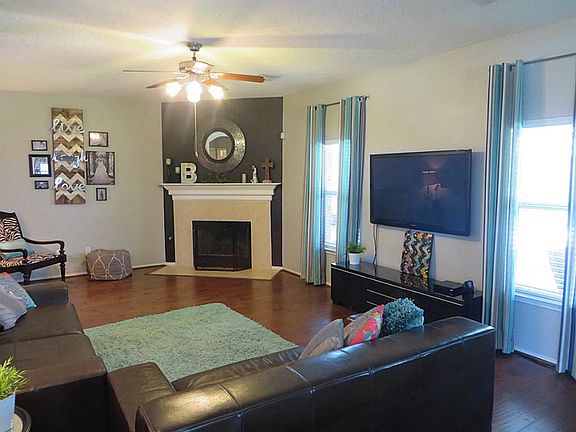 Large family room with gas fireplace and beautiful wood floors