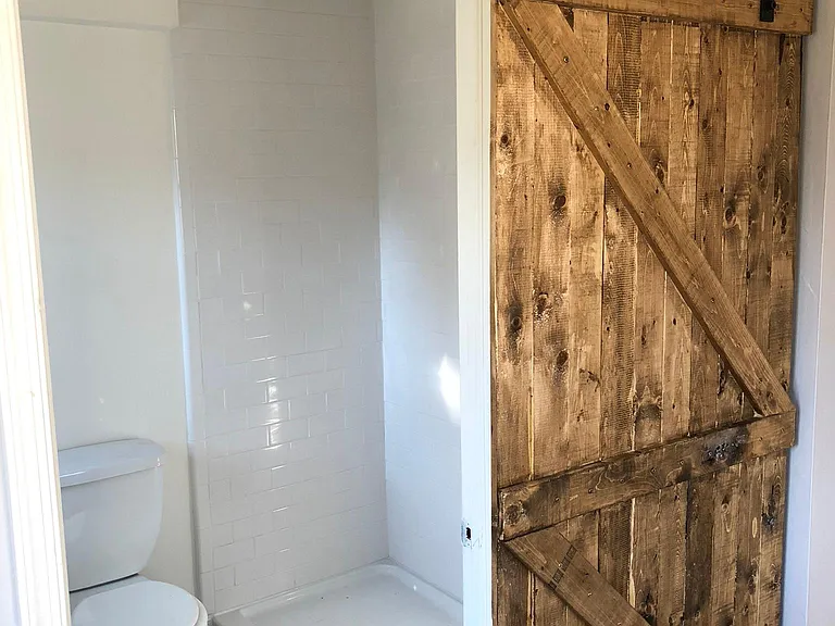 1st floor bathroom with new sliding barn door.