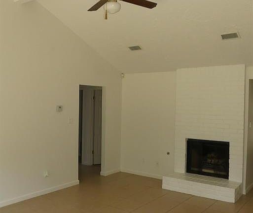 Vaulted ceilings in the Living Room. Neutral tile floors run throughout this home.