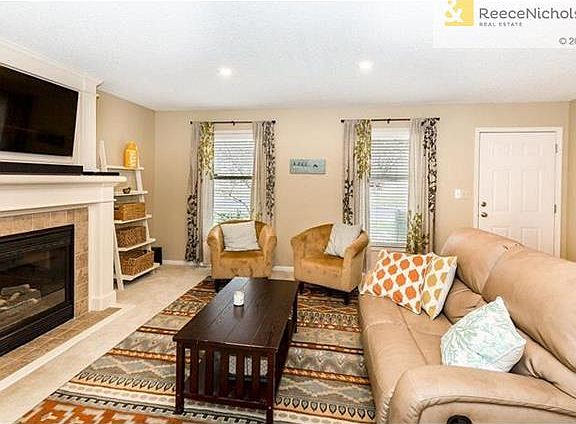 Wide living room with extra tall windows make for a bright open room to enjoy the company of friends and family.
