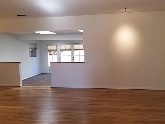 Living room looking into family room with skylights