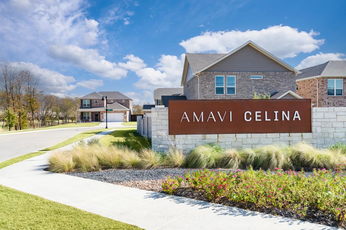 A distinctive community entry framed by landscaped greens and sidewalks, offering a warm first impression of this single-family neighborhood in Celina.