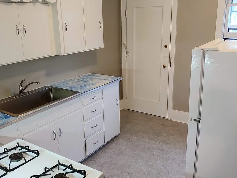 Updated appliances (gas stove!) 
New kitchen floor
Plenty of kitchen cabinets
Window looks out over the backyard