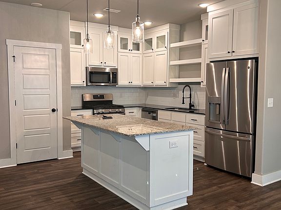 Kitchen and dining room. Tons of cabinet space, a pantry, and stainless steel appliances.