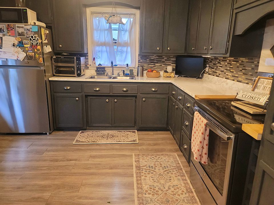 Newly updated Kitchen photo with new stainless steel refrigerator and stove.