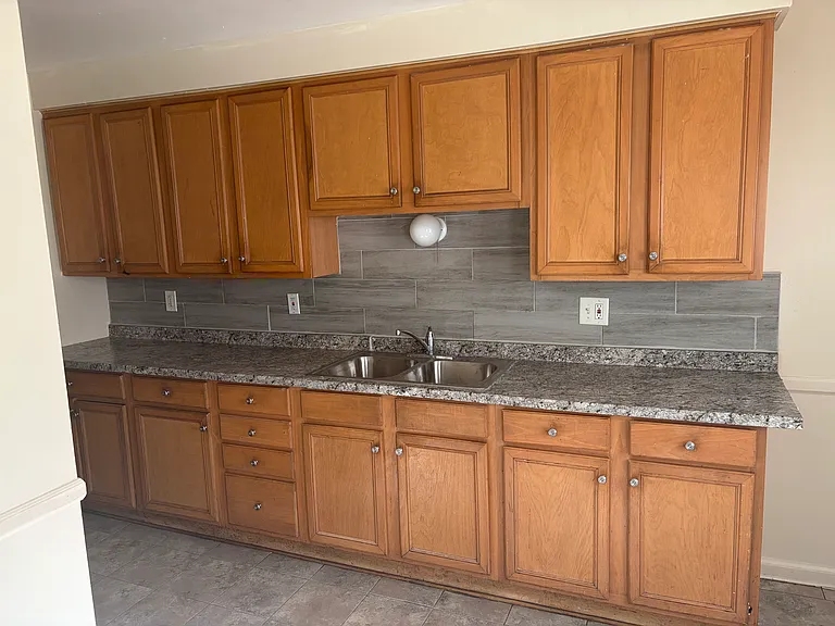 Kitchen cabinets, countertop, and stainless steel sink