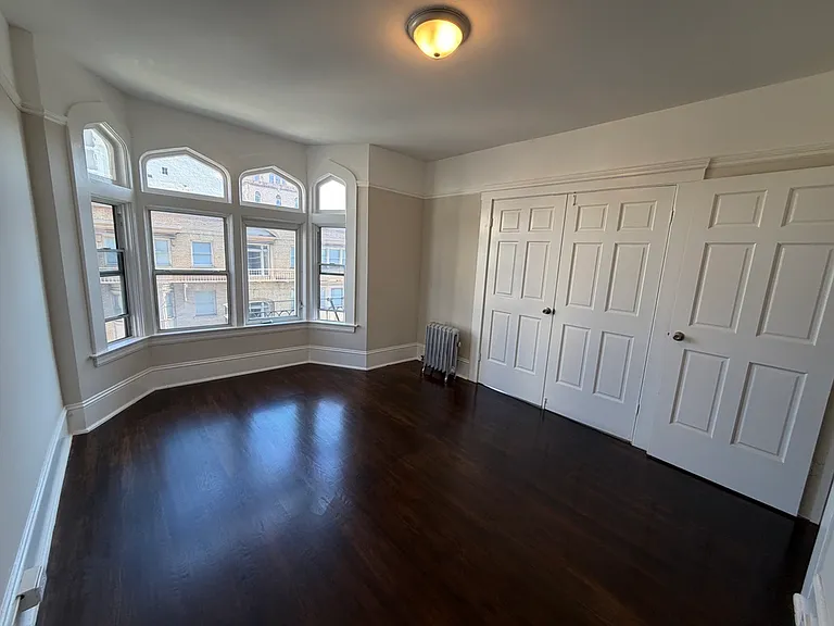 Left room - double doors separate the two rooms of this unit. There are 3 rooms total - living room, bedroom, kitchen.