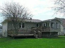 Back, including four season room and deck built around tree.