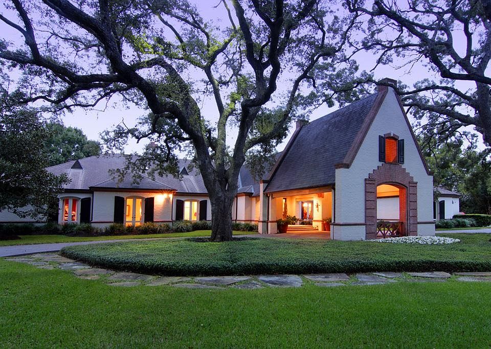 Traditional 5 bedroom home on 1.8 acres with mature trees, manicured grounds and lake frontage in the backyard