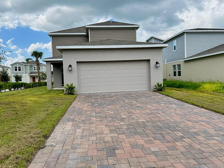 two-car garage, along with a paved driveway that provides additional parking for up to two more vehicles.