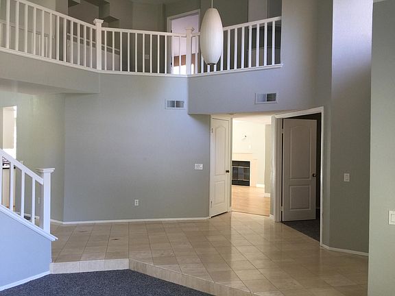 Entry way, Custom Light Fixture. Marbled floors, step down formal living room, stairs and cat walk to bedrooms.