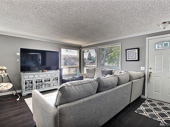 Entryway Opens into Well-Lit Living Room.