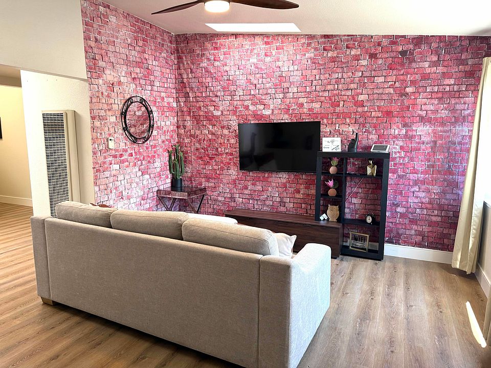 Living room with tapestry "brick" wall.