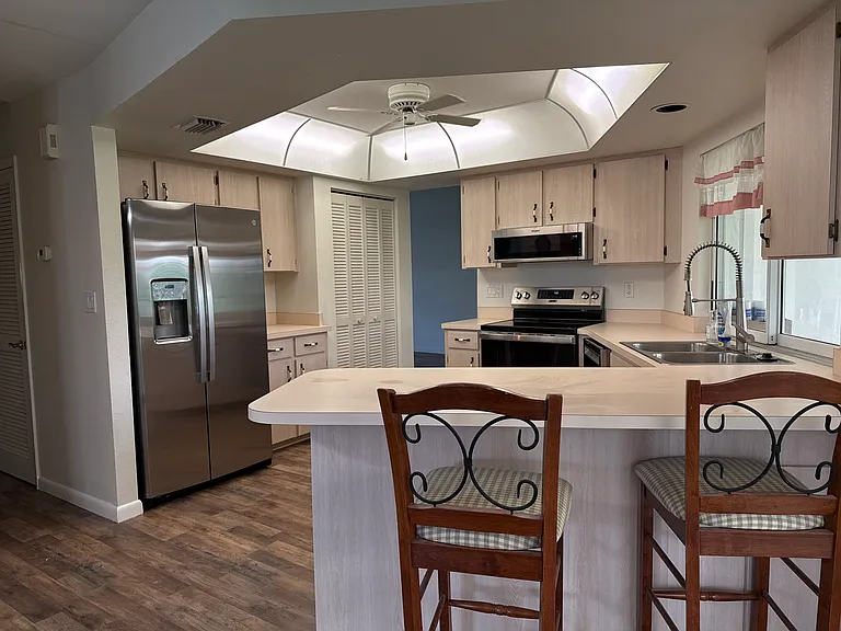 Kitchen with breakfast bar and new stainless-steel appliances