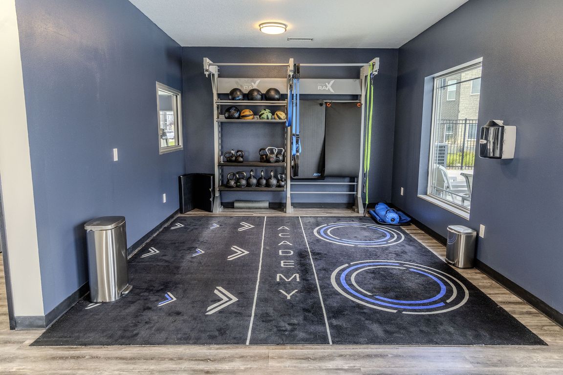 The fitness center is equipped for full-body workouts, including resistance bands, medicine balls, and kettlebells.