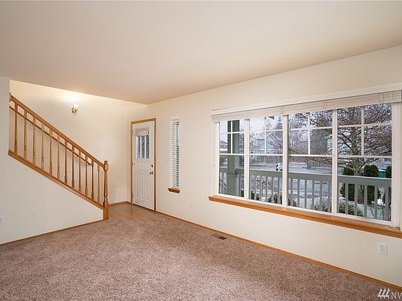 Inviting entry with abundant natural light and new carpet just installed throughout home.