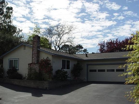 Looking Southwest toward the 2 car garage, entry, and living room with fireplace.
