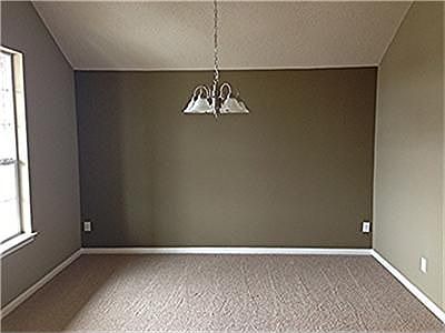 Gorgeous formal dining with carpet, accent wall and double windows.