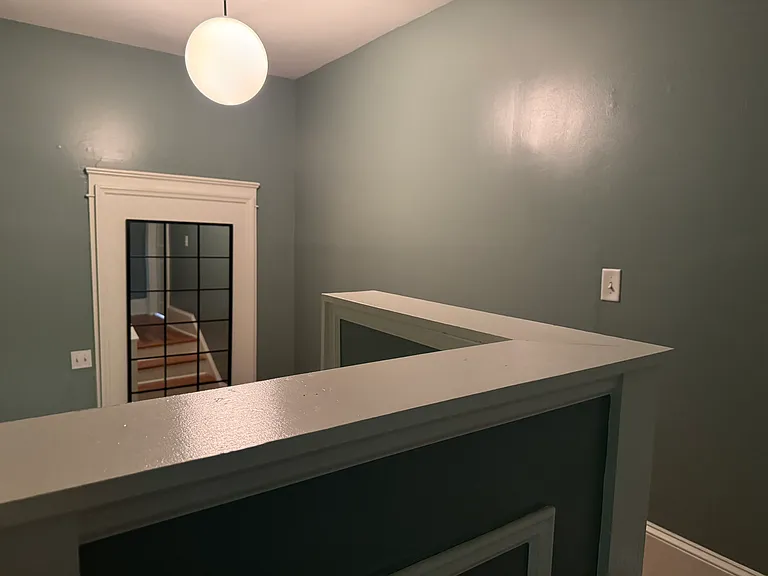 Hallway / Downstairs w/ vintage fixtures and brand new mirror.