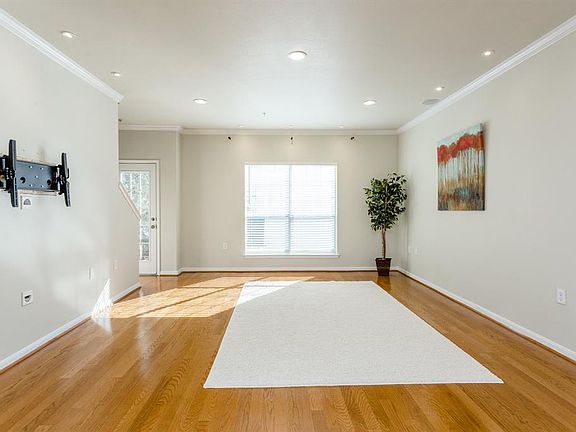 The main living area is located on the second floor. The open concept rooms including the living area, dining area, kitchen and breakfast room which together create a wonderful home for easy living and great entertaining. Notice the large windows whi