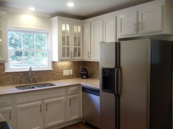 Updated kitchen with granite counter tops, mosaic stone back splash, new cabin