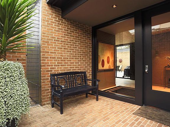 The interior entrance is very inviting with walls of glass, brick accent wall, portuguese limestone floor and high ceilings.