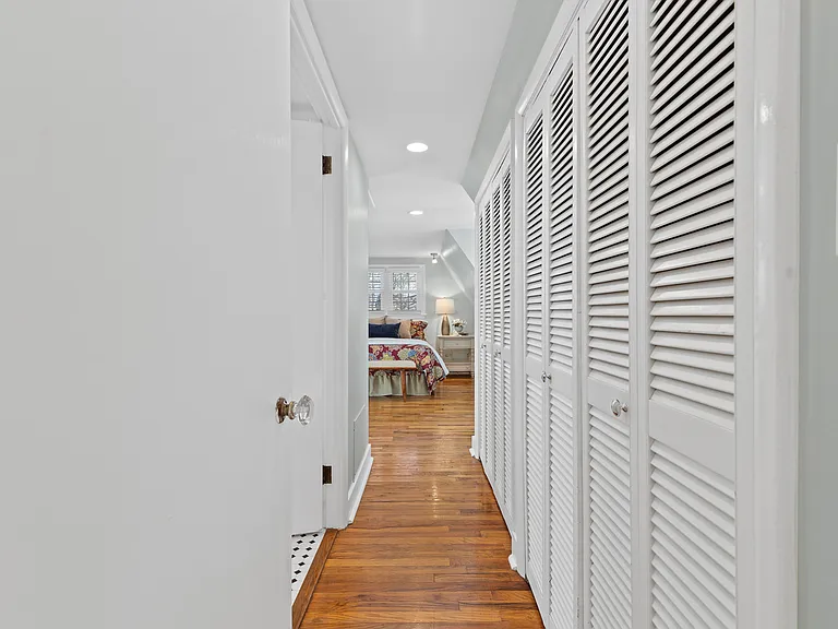 Primary bedroom with private bath on left side and closets on the right side