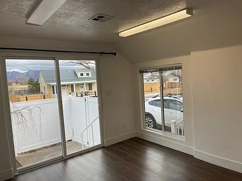 View from the extra room off the livingroom, with sliding glass door to another yard