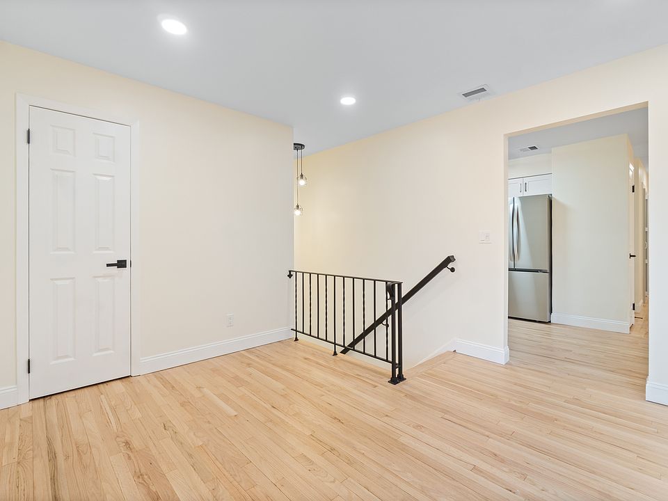 Stair landing with view of coat closet