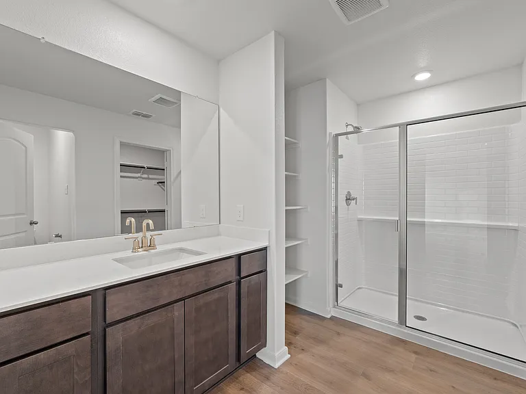 The master bathroom has a large glass, walk-in shower.