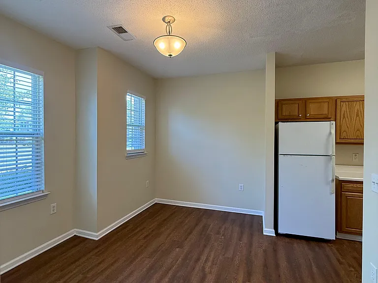 Another view of dining room and open kitchen. Refrigerator included.