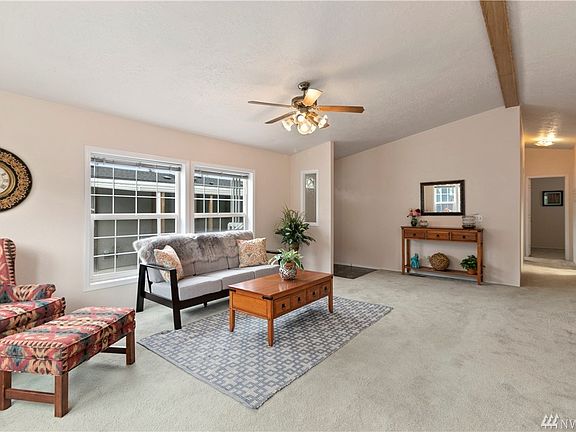 Living room and Hallway showing how much light lives in this home.You can get a good feeling how spacious the ceiling is.