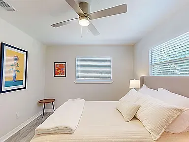 Furnished private room with queen bed, sitting area, and privacy lock, perfect for longer-term stays