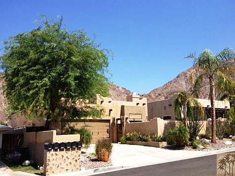 This beautiful Santa Fe home features a front loaded pool, spa and desert landscaping.