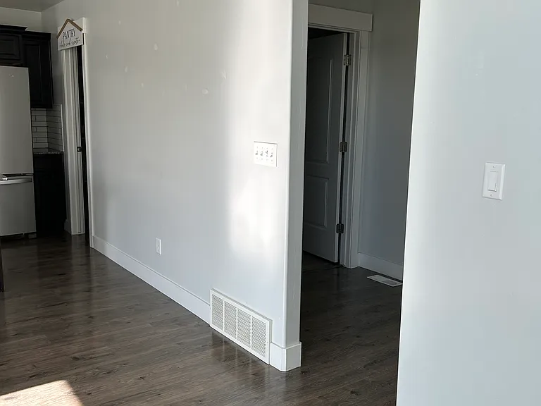 walkway to garage, hallway closet and half bath