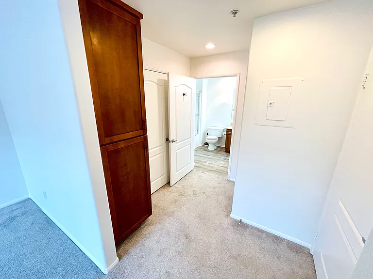 Hallway to In-unit Laundry + Walk-in Closet + Bathroom