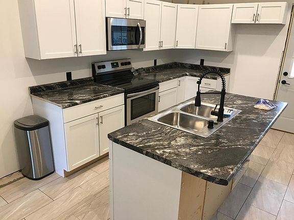 Completely remodeled 'farmhouse' kitchen with island - new counters, cabinets, flooring and all new appliances (stove, microwave, fridge and dishwasher)