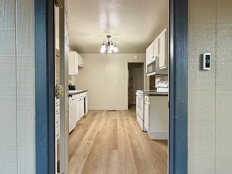 Front door entrance leading into kitchen