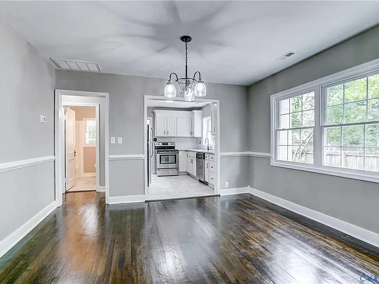 View of the dining room- or flex space! the hallway to the left is where the full bathroom is located.