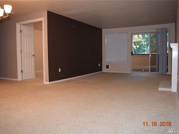Main living area opens up as you enter the unit with a Mocha colored accent wall in the living room