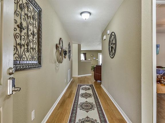 Entry hall leads to secondary bedrooms (on the right) and family room/kitchen/dining.  Nice Bamboo flooring!