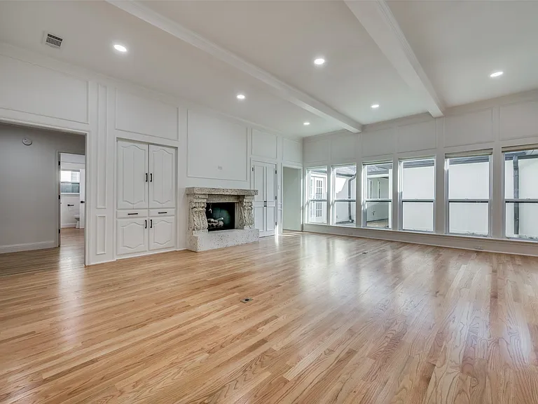 Large family room with fireplace and wet bar (behind double doors to right of FP)