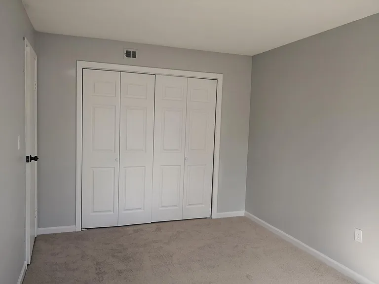 2nd bedroom with new carpet and closet