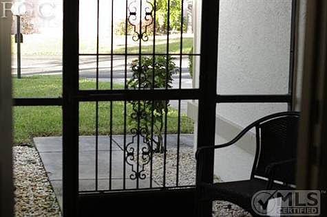 Concrete pad from outside leads into the decorative screened in foyer.