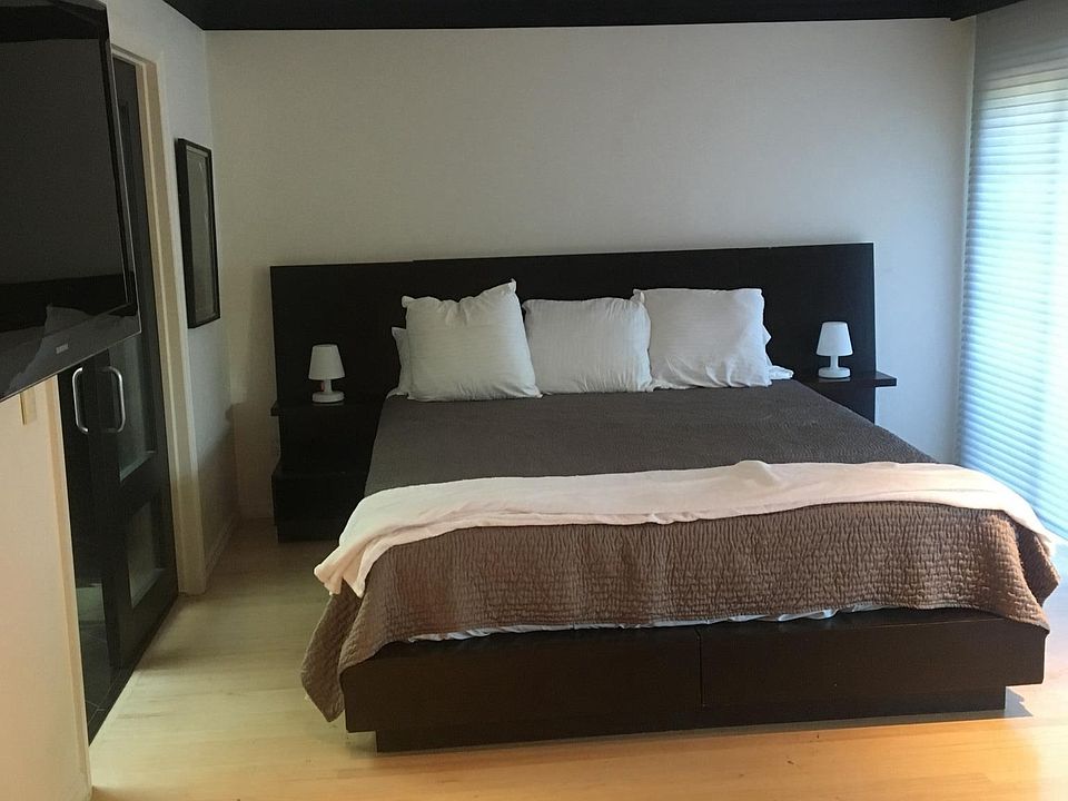 master bedroom with fire place, office desk, balcony